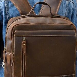 Brown Leather Backpack with Structured Design and Metal Zippers